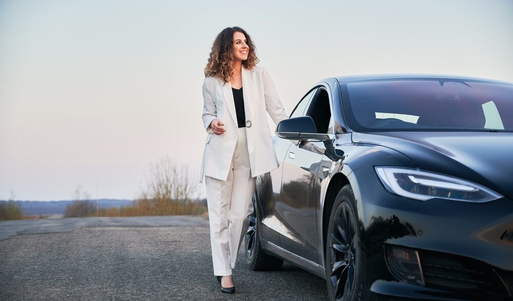 woman next to a car.