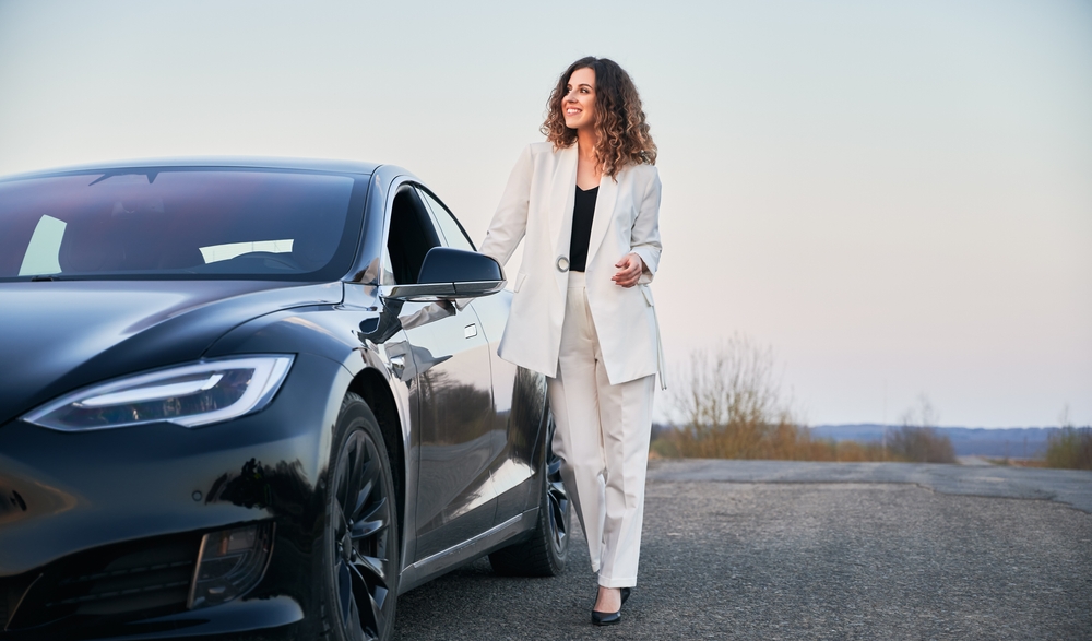 woman next to a car.