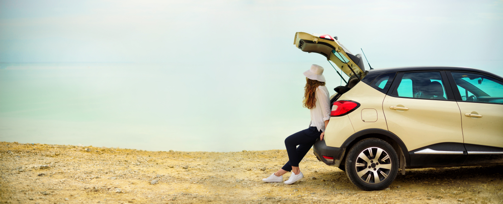 woman sit in the car trunk.