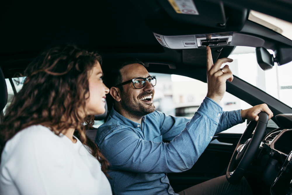 Happy couple inside a car.