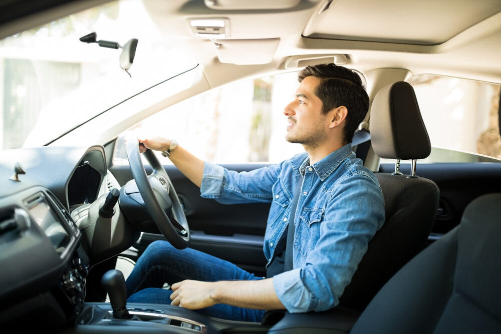 Man driving insider his car.