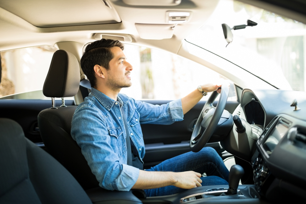 Man driving insider his car.